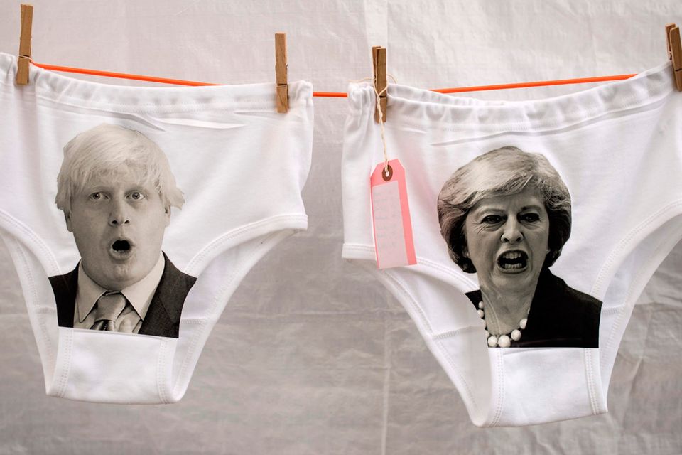 Images of Conservative Party leadership contender, Boris Johnson (L), and current Leader, and Britain's Prime Minister, Theresa May, are pictured on pairs of pants displayed at the Glastonbury Festival of Music and Performing Arts on Worthy Farm near the village of Pilton in Somerset, South West England, on June 26, 2019. (Photo by Oli SCARFF / AFP)OLI SCARFF/AFP/Getty Images