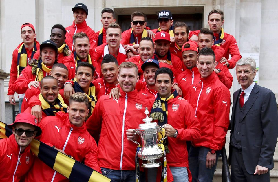 Arsene Wenger and his Arsenal players outside the Town Hall yesterday