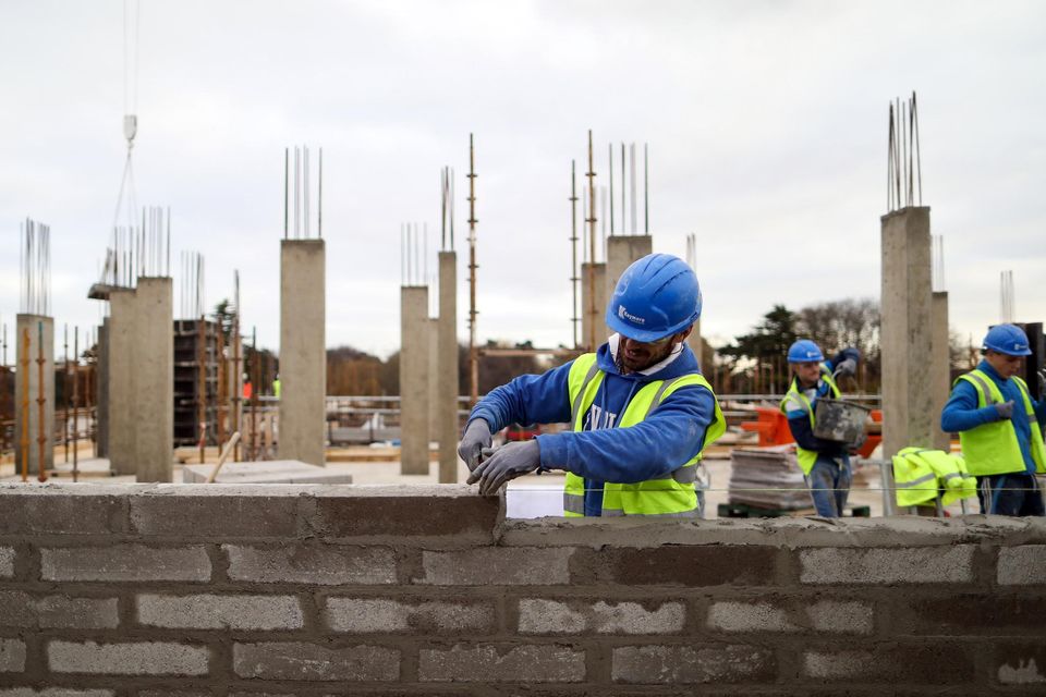 A construction worker lays a row of bricks on a Cairn Homes construction site in Dublin. Photo: Bloomberg