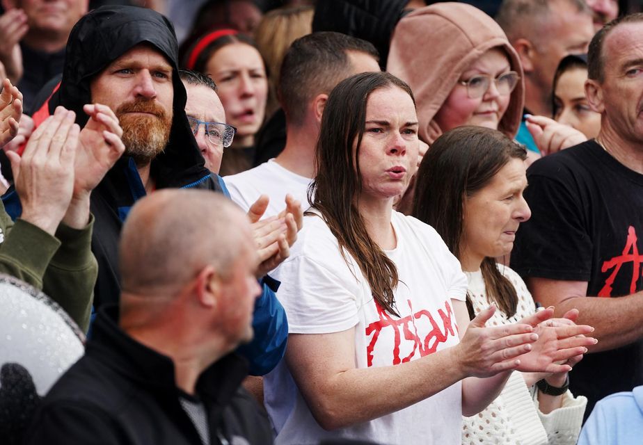 People line the streets of Finglas for a farewell gathering for Aslan frontman Christy Dignam before his private funeral (Brian Lawless/PA)