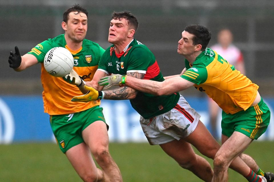 Mayo's Jordan Flynn in action against Hugh McFadden and Caolan Ward of Donegal. Photo: Sportsfile