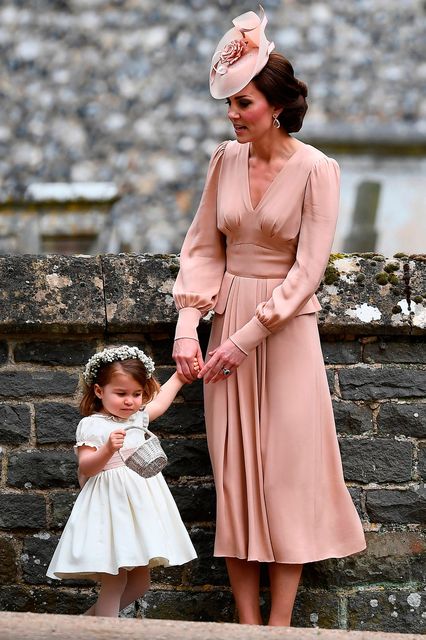 The Duchess of Cambridge with her daughter Princess Charlotte outside St Mark's church in Englefield, Berkshire, following the wedding of Pippa Middleton and James Matthews.