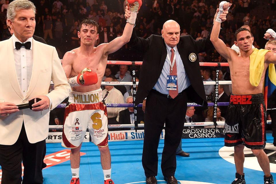 Anthony Crolla (2nd left) after his WBA World Lightweight Championship fight against Darleys Perez was called a draw with announcer Michael Buffer (left), at Manchester Arena, Manchester