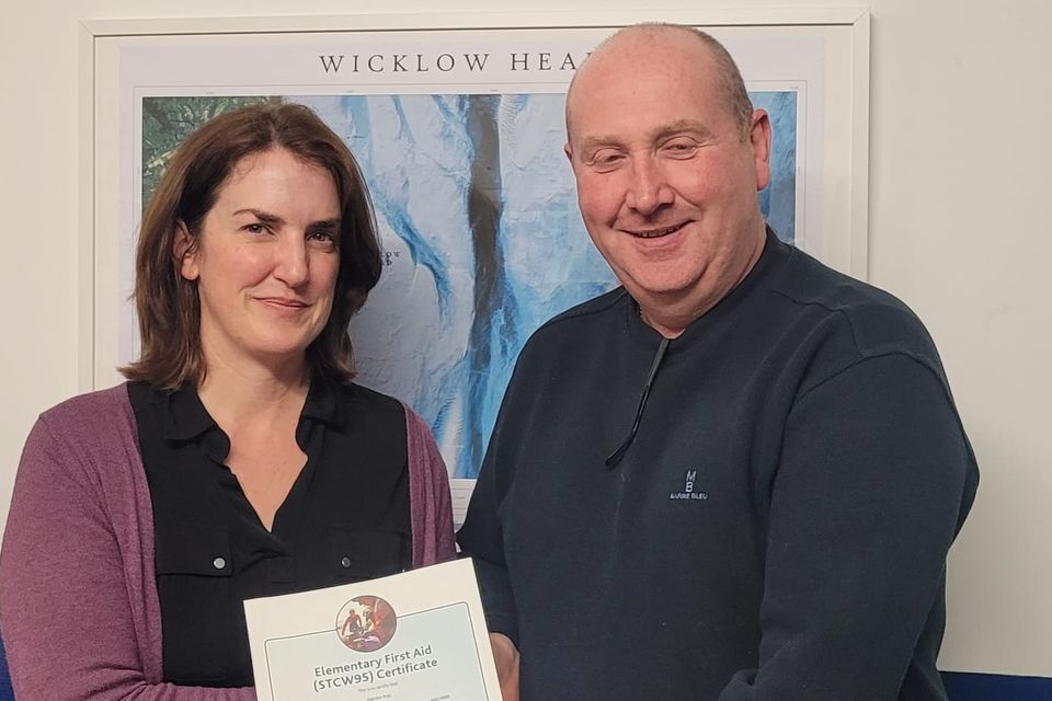 Wicklow RNLI volunteer Deirdre Ross receiving her first aid certification from coxswain Nick Keogh.
