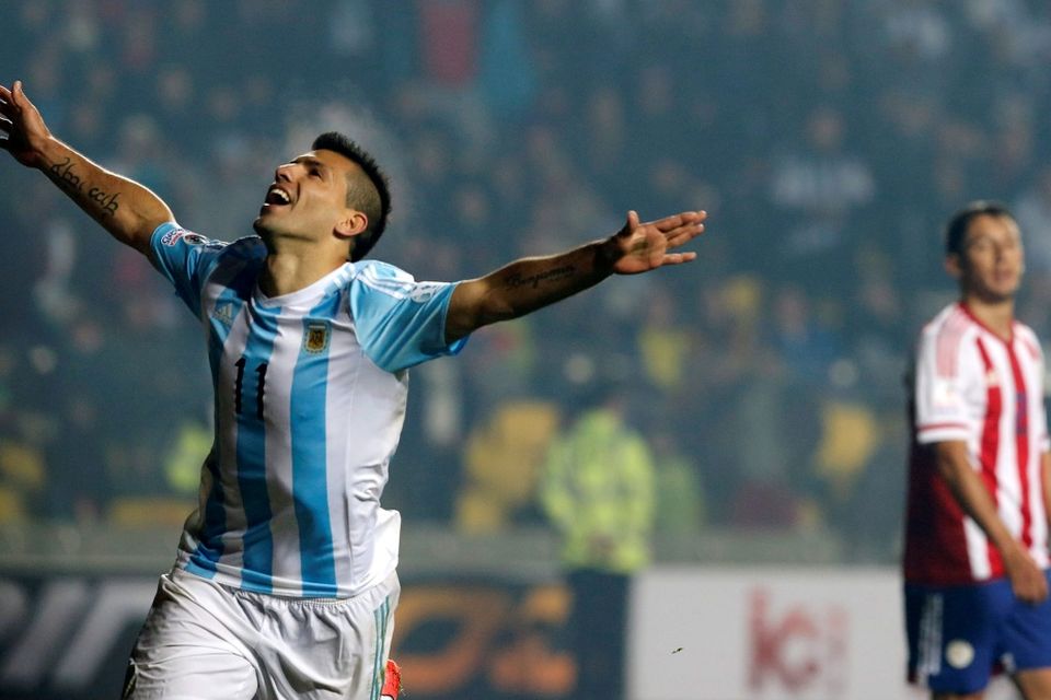 Argentina's Sergio Aguero celebrates after scoring a goal as Paraguay's Ivan Piris looks on during their Copa America 2015 semi-final soccer match at Estadio Municipal Alcaldesa Ester Roa Rebolledo in Concepcion, Chile, June 30, 2015. REUTERS/Andres Stapff