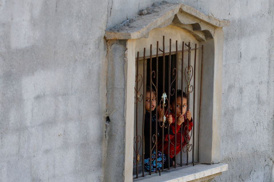 Children look out from a window in Khan Younis, in the southern Gaza Strip. Photo: Reuters