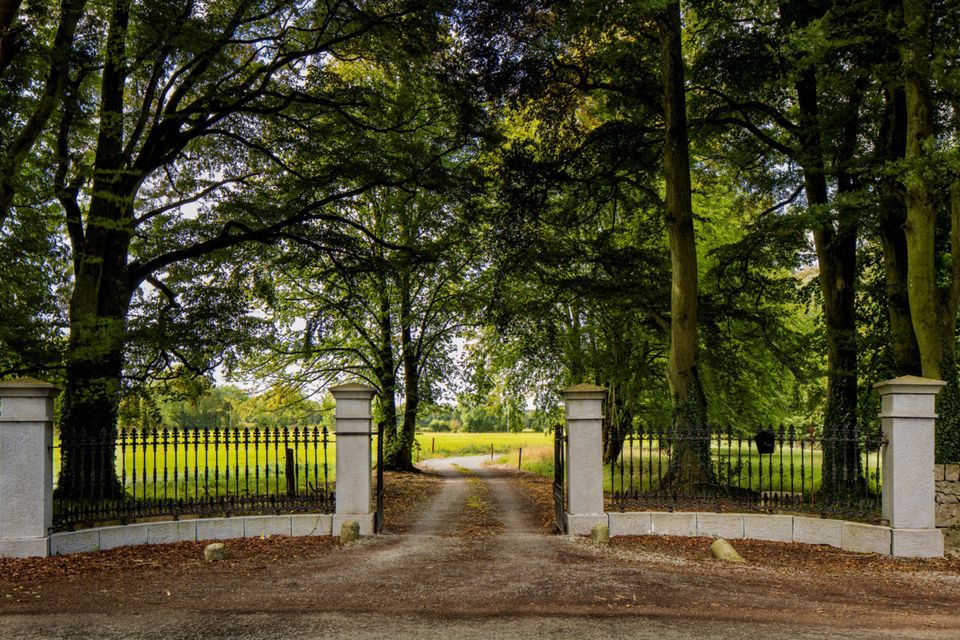 The original stone pillars mark the entrance to the property.