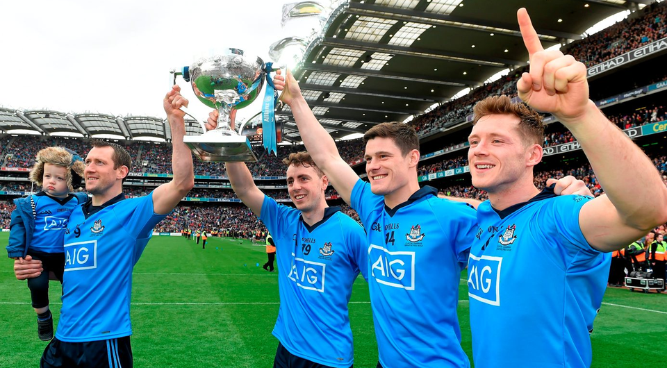 Dublin players Denis Bastick, holding his son Aiden, Cormac Costello, Diarmuid Connolly and Paul Flynn celebrate after beating Kerry in Croke Park Photo: Dean Cullen / SPORTSFILE