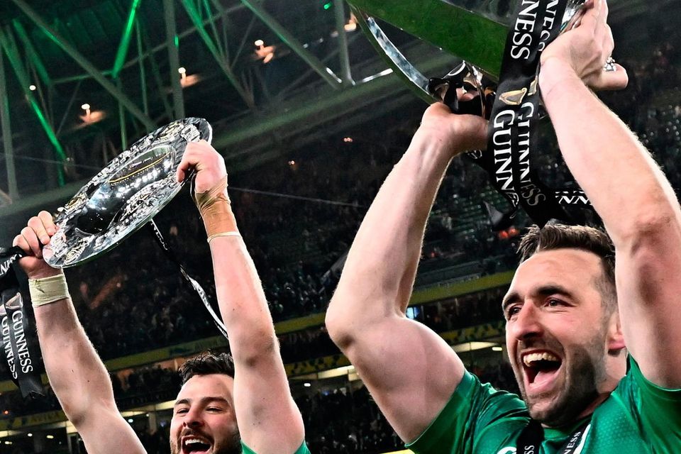 Robbie Henshaw, left, and Jack Conan of Ireland celebrate with the Six Nations and Triple Crown trophies after the Guinness Six Nations Rugby Championship match between Ireland and England at Aviva Stadium in Dublin.
