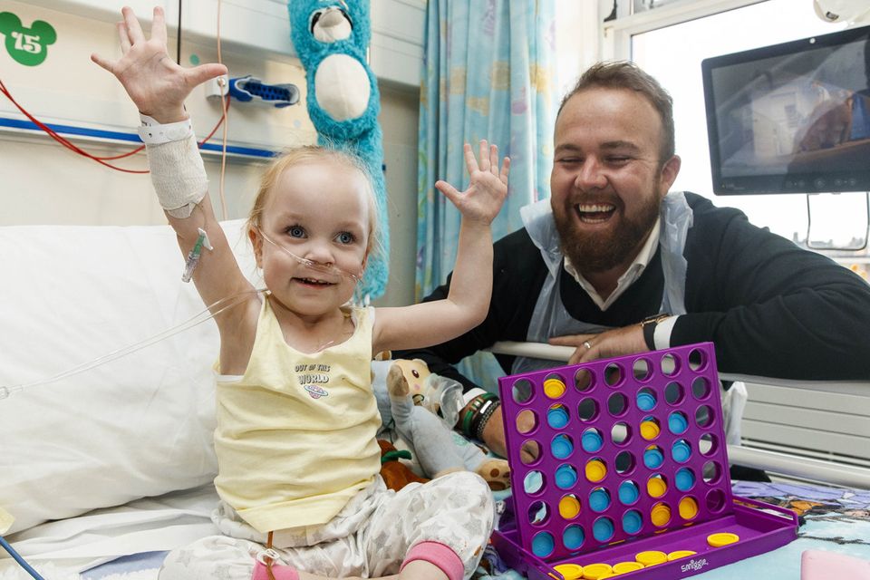 All smiles: Alana Brennan (3) from Coolock, Dublin, meets golfer and 2019 Open champion Shane Lowry at Temple Street as he was announced as an official ambassador for the hospital. Photo: Andres Poveda