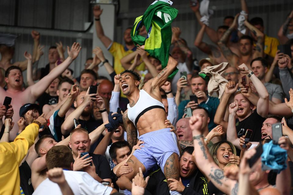 Raphinha celebrates with the Leeds fans after the club avoided relegation from the Premier League on the final day of last season with a win at Brentford. Photo: Getty