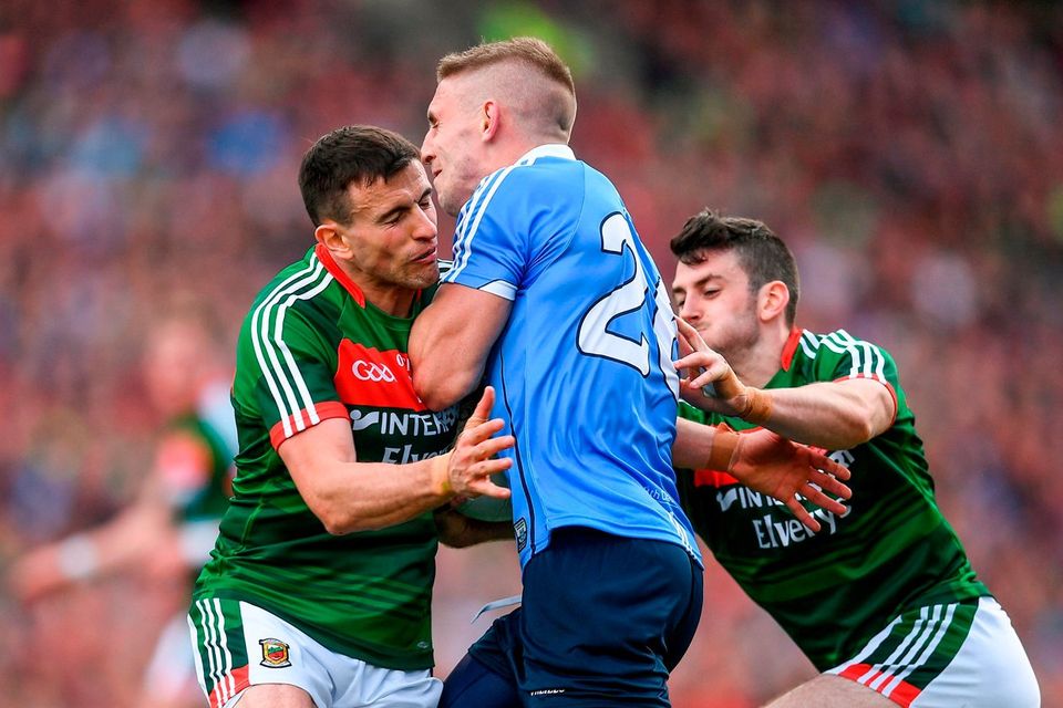 Eoghan O'Gara of Dublin in action against Jason Doherty, left, and Brendan Harrison of Mayo during the GAA Football All-Ireland Senior Championship Final match between Dublin and Mayo at Croke Park in Dublin.