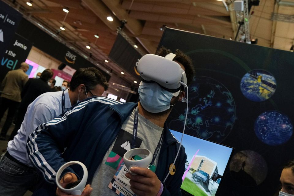 A person wears virtual reality goggles at the European Space Agency (ESA) stand in the Web Summit, Europe's largest technology conference, in Lisbon, Portugal, November 2, 2021. REUTERS/Pedro Nunes