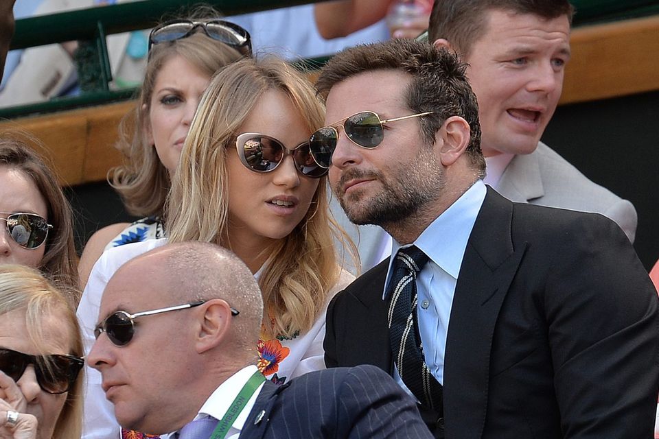 Bradley Cooper sits with his girlfriend Suki Waterhouse, near Brian O'Driscoll (back right) in the Royal Box on Centre Court