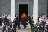 thumbnail: Mourners watch as the coffin of Martina Hayes is carried from the Church of Saints Peter and Paul in Athlone