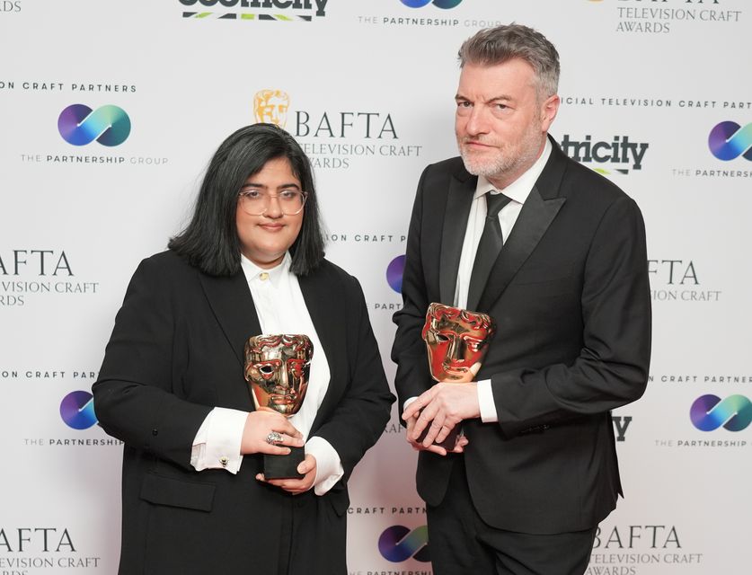 Charlie Brooker and Bisha K Ali with their awards for Black Mirror’s Demon 79 (Ian West/PA)