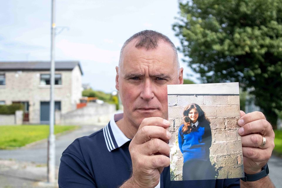 Ciara Breen's uncle James Coburn holds a photo of his neice wearing her school uniform