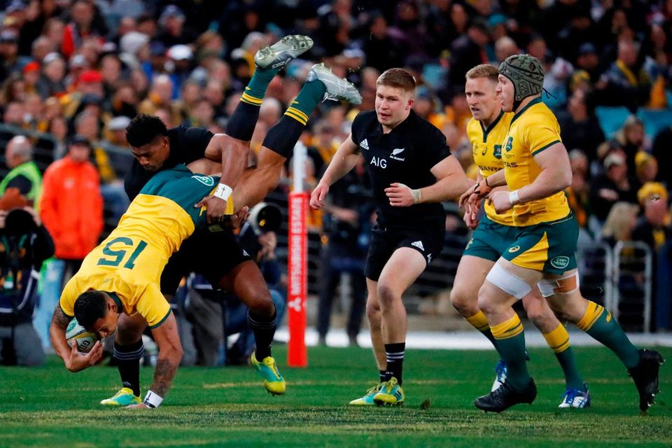 Australia's Israel Folau is tip tackled by New Zealand's Waisake Naholo