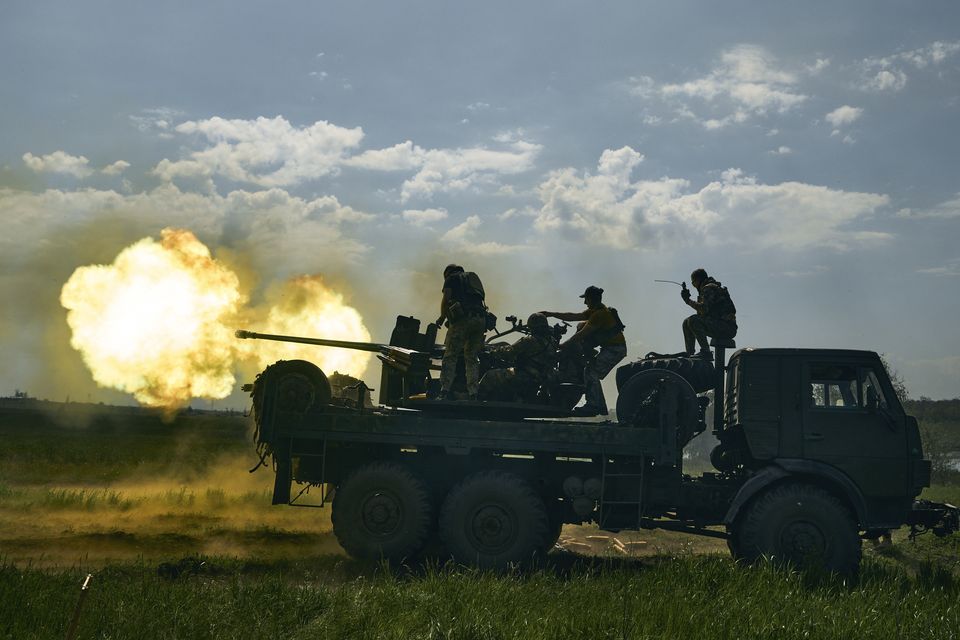 Ukrainian soldiers fire a cannon near Bakhmut (AP Photo/Libkos)