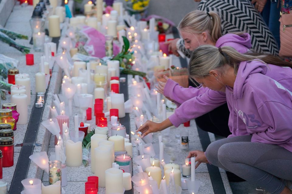 People light candles at the end of the vigil at Kickham Plaza in Clonmel. Photo: PA