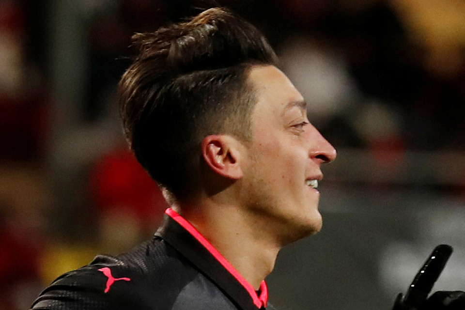 On target: Arsenal’s Mesut Ozil celebrates