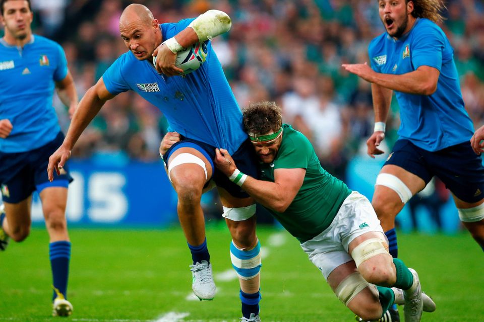 Italy's Sergio Parisse is tackled by Jamie Heaslip during yesterday's Pool D clash at the Olympic Stadium GETTY IMAGES
