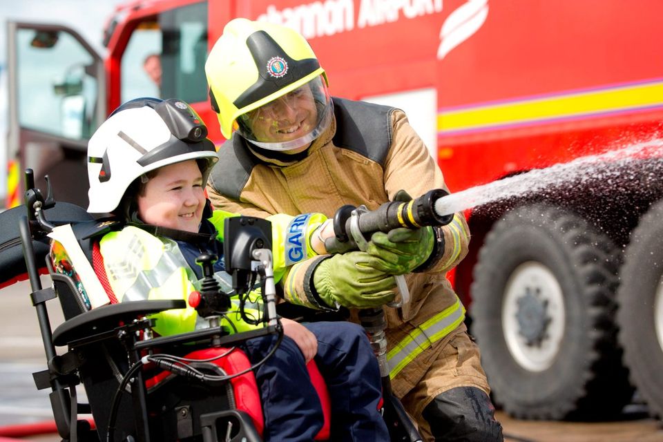 Garda Jordan Perez (8) with firefighter Eamonn Power. Photo: Sean Curtin