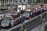 thumbnail: The funeral cortege of Laurence and Martina Hayes is accompanied by guards of honour from the Order of Malta and work colleagues of Mr Hayes