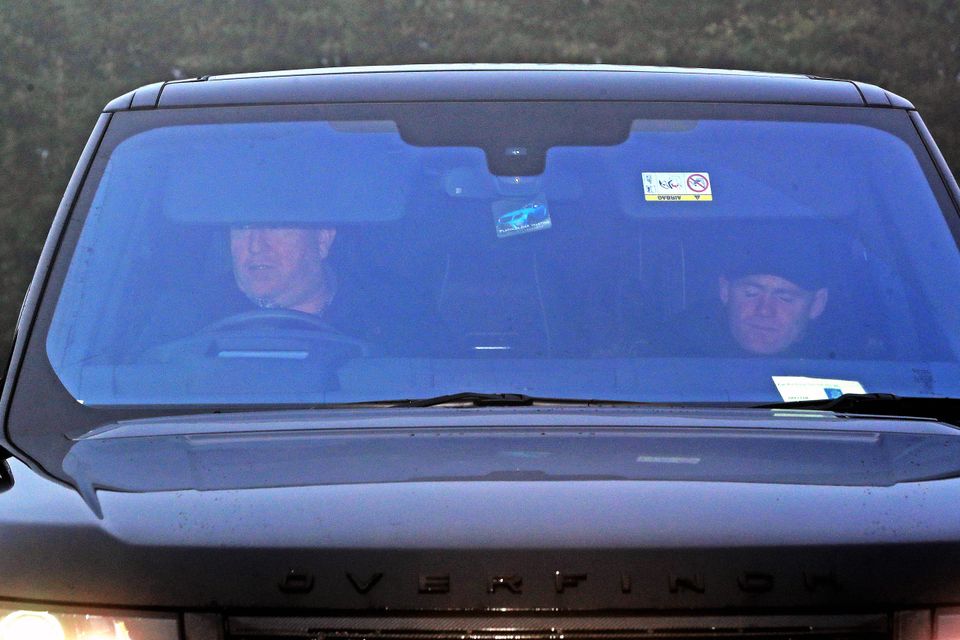 Wayne Rooney (right) is driven in to Everton's Finch Farm training ground after being banned from driving for two years