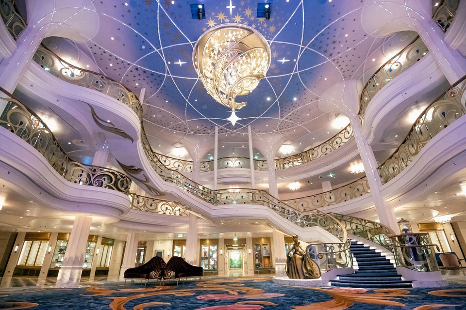 The Grand Hall on the Disney Wish, which rises three decks high and is dominated by a resplendent chandelier. PA Photo/Disney Cruise Line/Amy Smith.