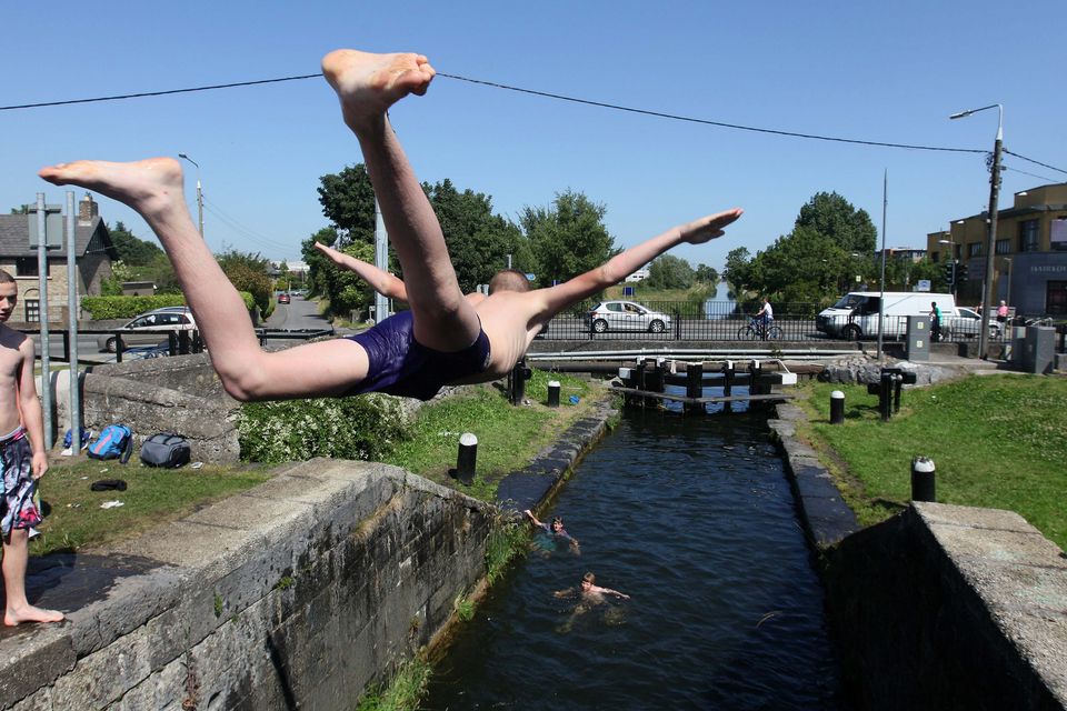 Kids jump into the grand canal in Clondalkin to cool down from the summer heat