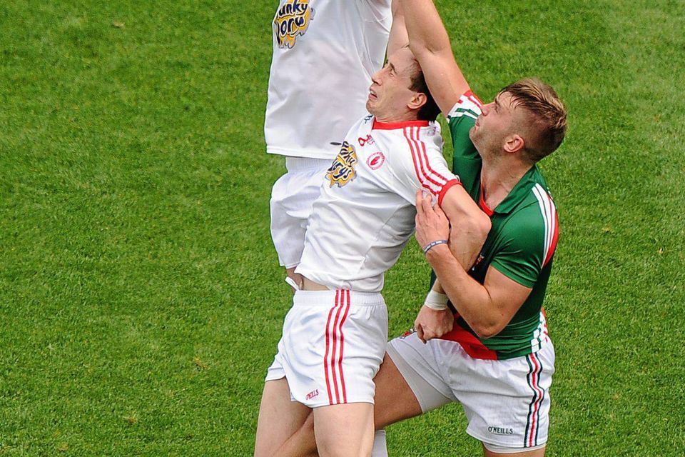 Aidan O'Shea, Mayo, in action against Sen Cavanagh, left, and Colm Cavanagh