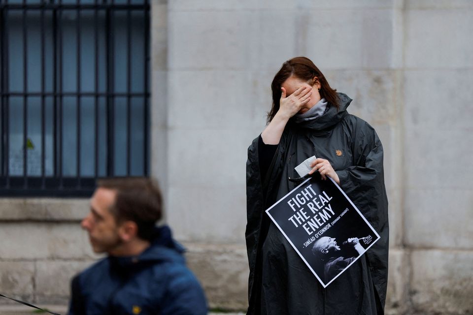 Sonya Wellhausen holds a sign as fans gather to pay tribute to late singer Sinéad O'Connor in Dublin. Photo: Reuters/Clodagh Kilcoyne