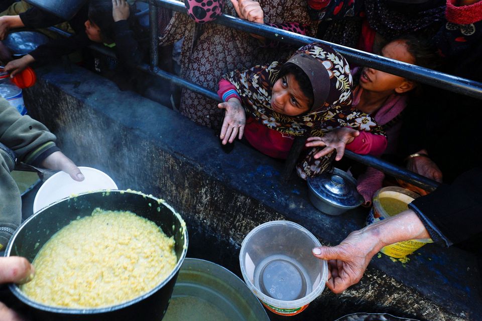A child reacts as Palestinians wait to receive food during the Muslim holy fasting month of Ramadan, as the conflict between Israel and Hamas continues, in Rafah, in the southern Gaza Strip. Photo: Reuters