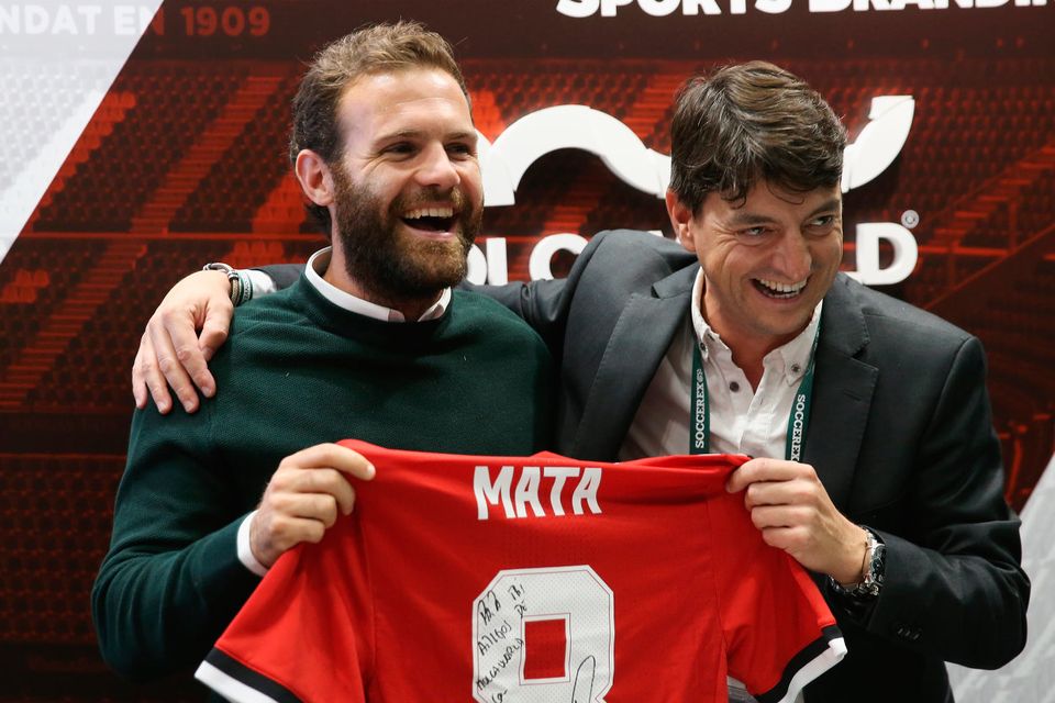 Juan Mata of Manchester United poses on the Molca World stand with a signed shirt during day 2 of the Soccerex Global Convention at Manchester Central Convention Complex