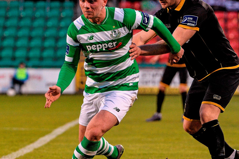 Shamrock Rovers' Dean Clarke tries to evade a challenge from Dundalk's Dane Massey Photo: David Maher / SPORTSFILE