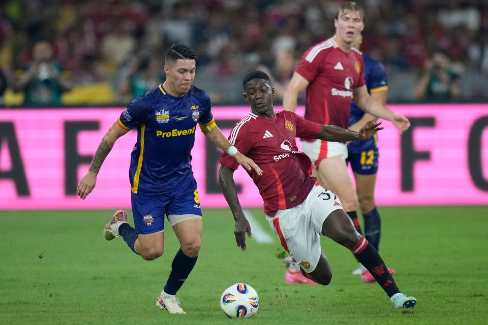 Manchester United's Kobbie Mainoo, right, fights for the ball with Asean All-Star Malaysia's Ezequiel Aguero during the Challenge Cup Malaysia 2025 in Kuala Lumpur, Malaysia. Photo: AP Photo/Vincent Thian