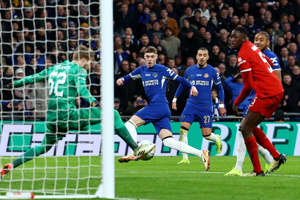 Liverpool's Caoimhin Kelleher in action as he saves a shot from Chelsea's Cole Palmer Action