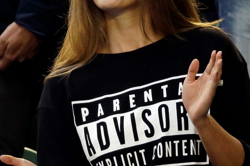Kim Sears, fiancee of Andy Murray of Britain, applauds before his mens singles final against Novak Djokovic, wearing a 'Parental Advisory Explicit Content' slogan top, in response to the swearing controversy at the previous match