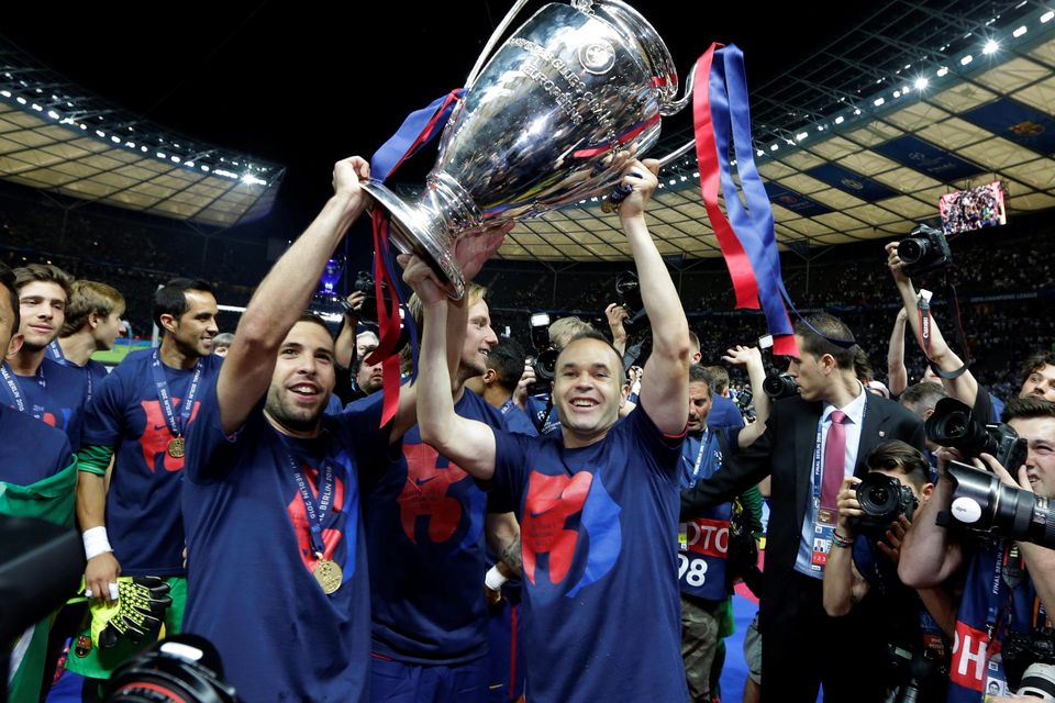 Barcelona's Andres Iniesta, centre, holds the trophy after the Champions League final