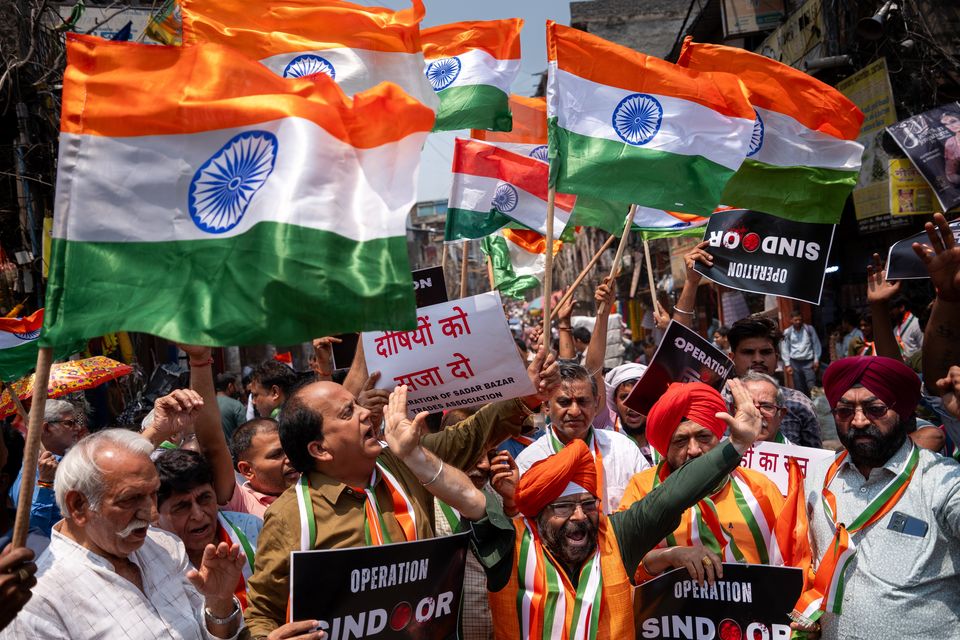 People wave Indian national flags and display banners during a protest against Pakistan in New Delhi. Photo: Getty