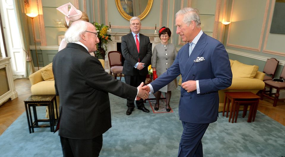 President Michael D Higgins shakes hands with the Prince Charles, who welcomed him to the UK for a five day state visit, at the Irish Embassy in central London