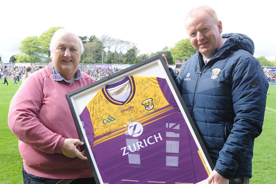 Photographer Ger Hore receiving a presentation of a Wexford jersey signed by the county Senior hurlers and footballers from Micheál Martin (Co. Chairman) in Chadwicks Wexford Park on Saturday, to mark his  contribution to local GAA coverage over many years. Photo: Jim Campbell