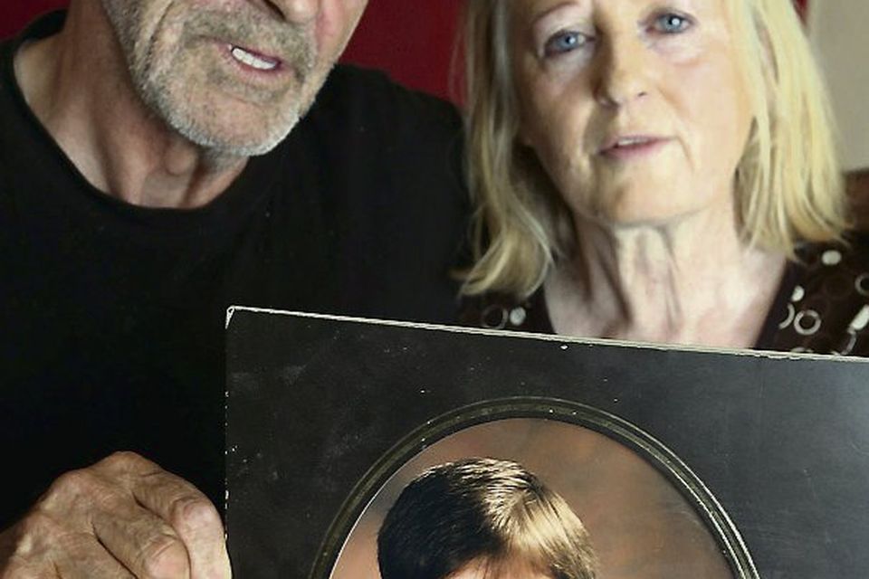 Larry and Elizabeth Johnson, parents of Dean Johnson, with a photo of him as a boy.
