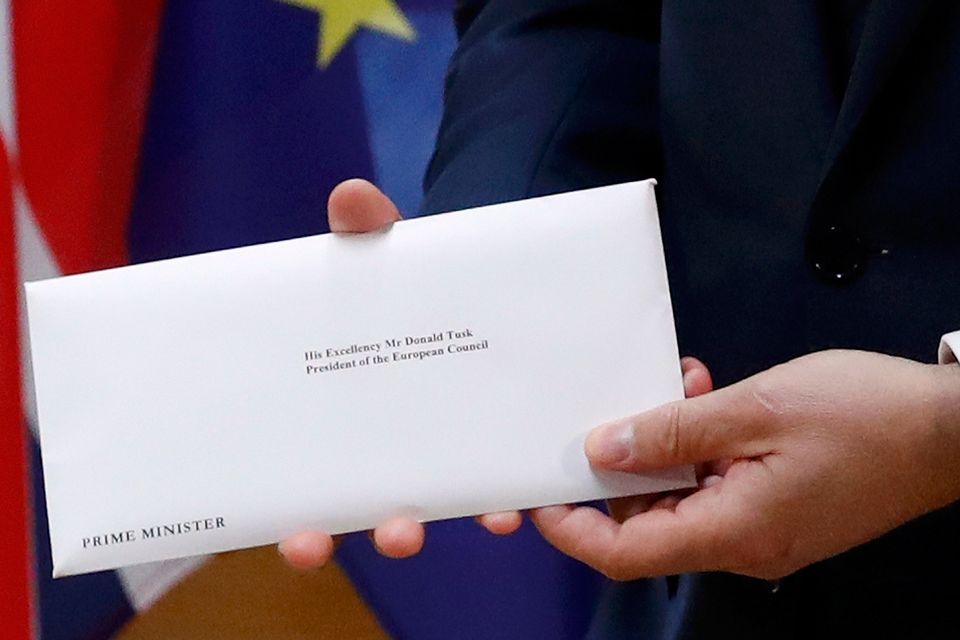 A detail shows EU Council President Donald Tusk who holds British Prime Minister Theresa May's Brexit letter which was delivered by Britain's permanent representative to the European Union Tim Barrow (not pictured) that gives notice of the UK's intention to leave the bloc under Article 50 of the EU's Lisbon Treaty in Brussels, Belgium, March 29, 2017.  REUTERS/Yves Herman
