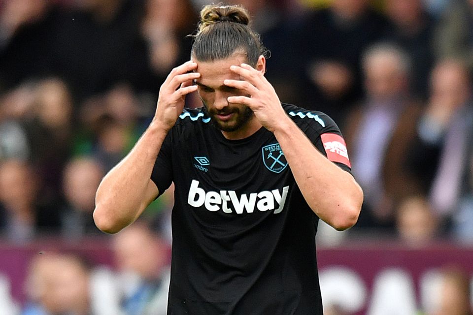 West Ham striker Andy Carroll leaves the field after being sent off for a second booking