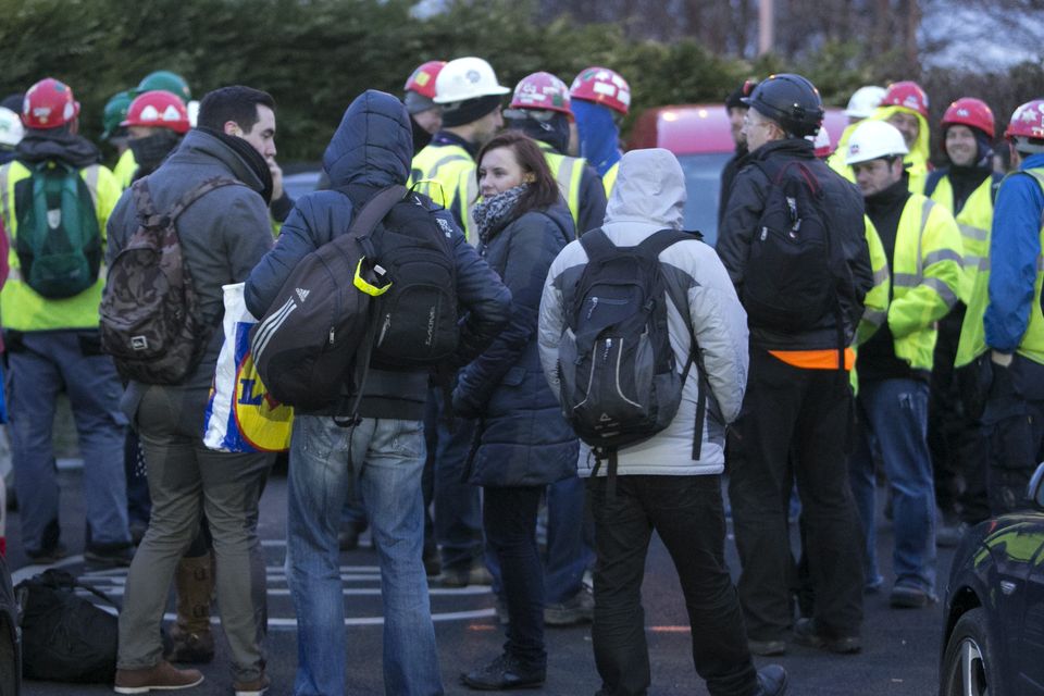 Workers outside the plant after the bomb scare this morning