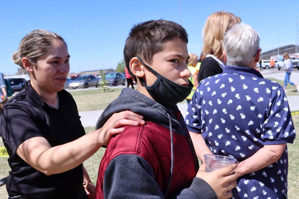Adela Rodriguez, left, walks with her son, Yandel Rodriguez, 12, at the school where pupils were shot (Natalie Behring/AP)