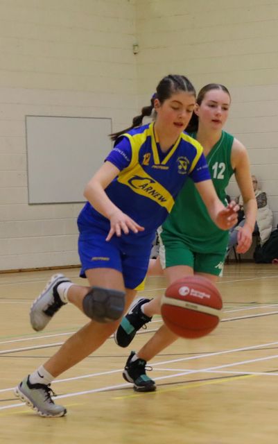 Coláiste Bhríde's Niamh Wafer takes the ball out of her defence.