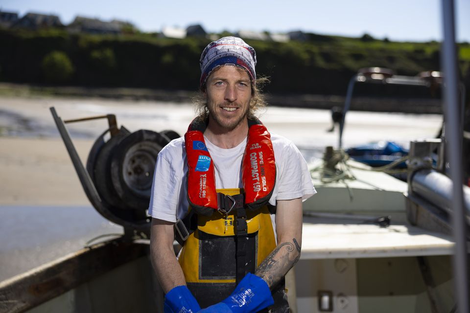 Fionn Ó Corraoin, pictured on his boat at Baile na nGall pier, An Rinn, Co Waterford, features in new RTÉ series Tarrac na Farraige. Photo: Patrick Browne
